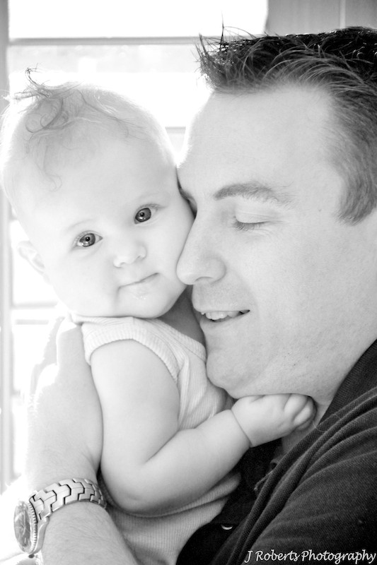 Dad having a cuddle with baby girl - family portrait photography sydney